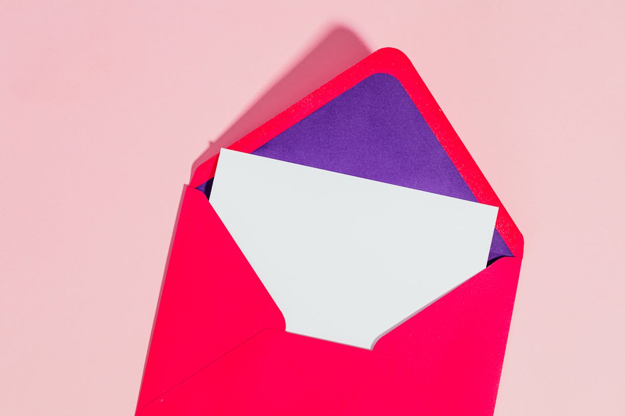 A brightly colored red envelope with a blank card inside, perfect for mockup designs.